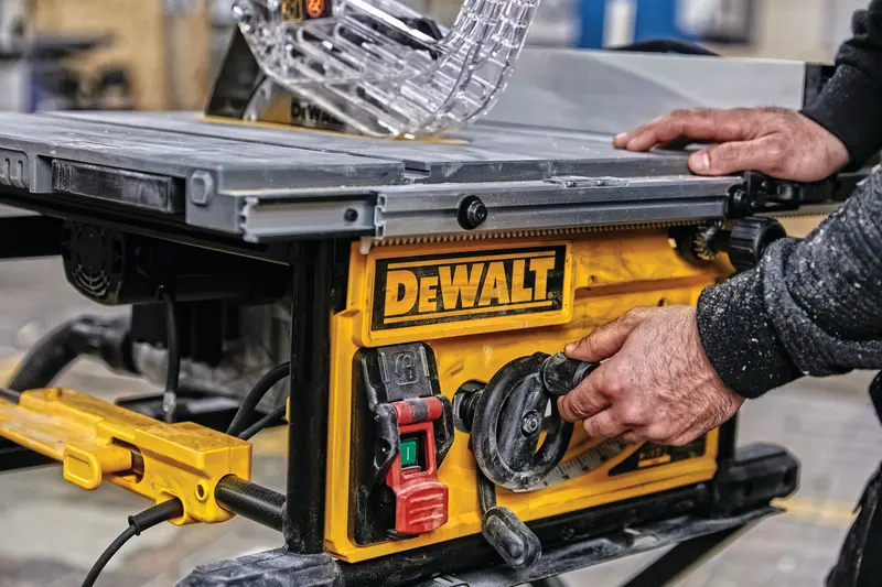 Photo of DEWALT table saw, SKUs DWE7492SET, DWE7492, DWE7492-QS, close-up of controls in workshop setting.